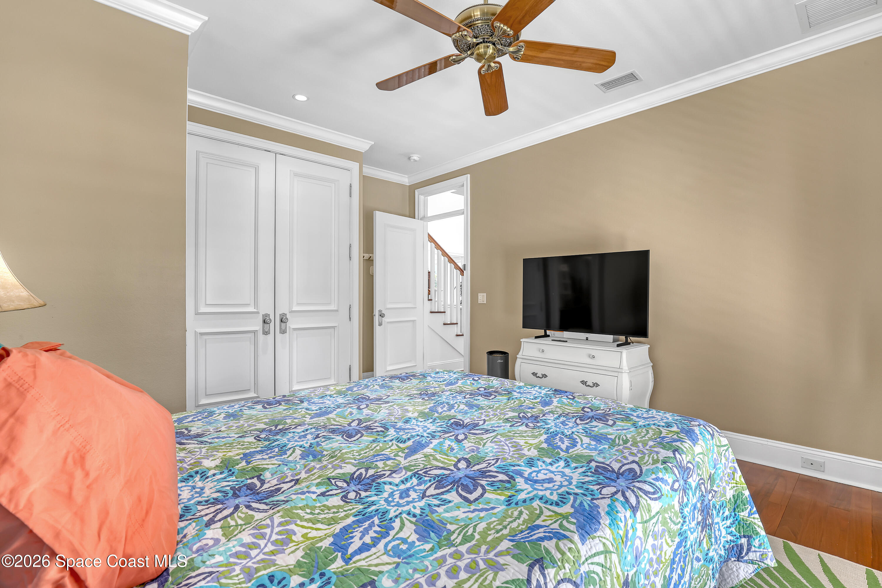 4200 Mustang Road Melbourne, FL 32934 - Photo 42 of 58 a bedroom with a bed and a flat screen tv