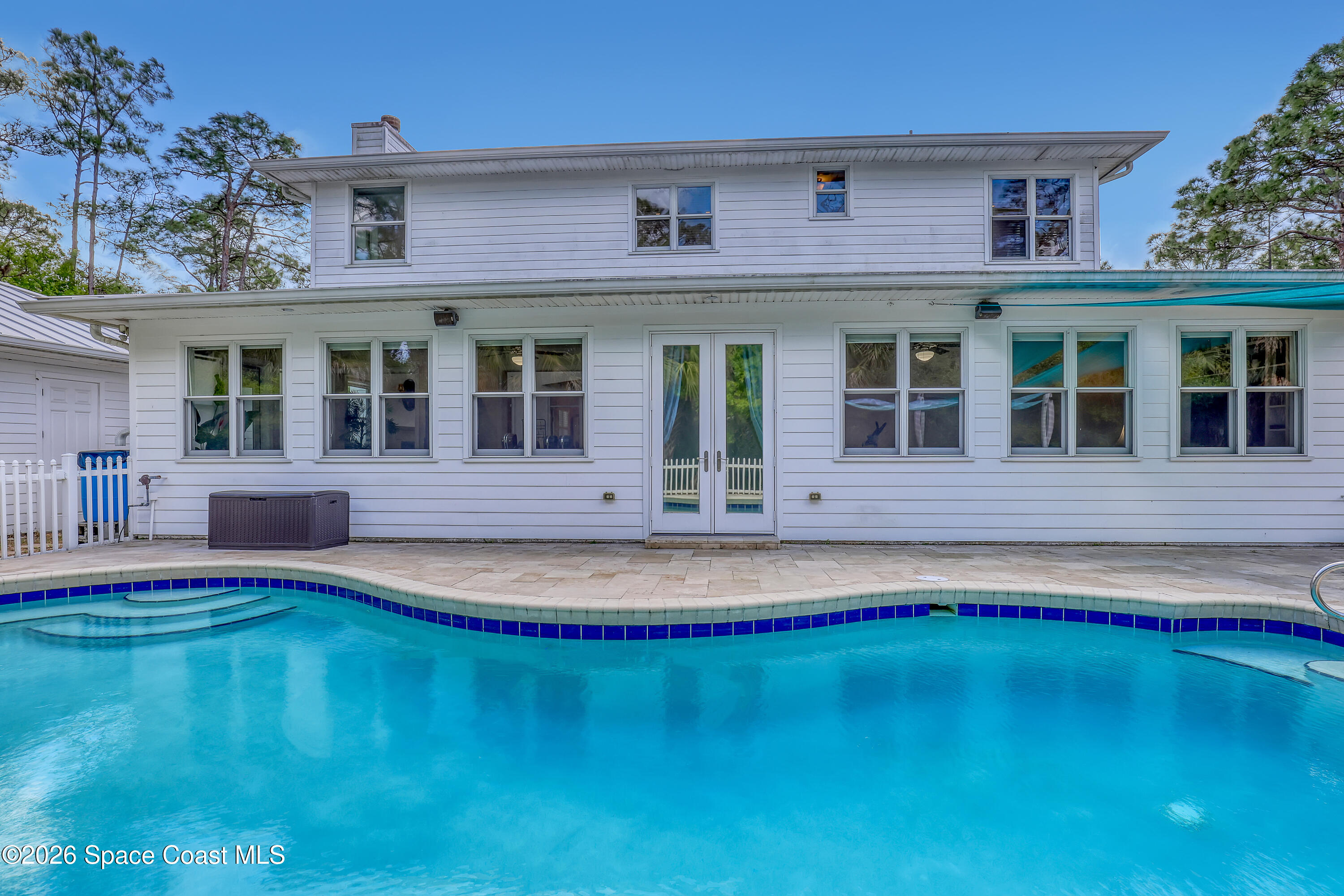 4200 Mustang Road Melbourne, FL 32934 - Photo 49 of 58 a front view of a house with swimming pool and porch