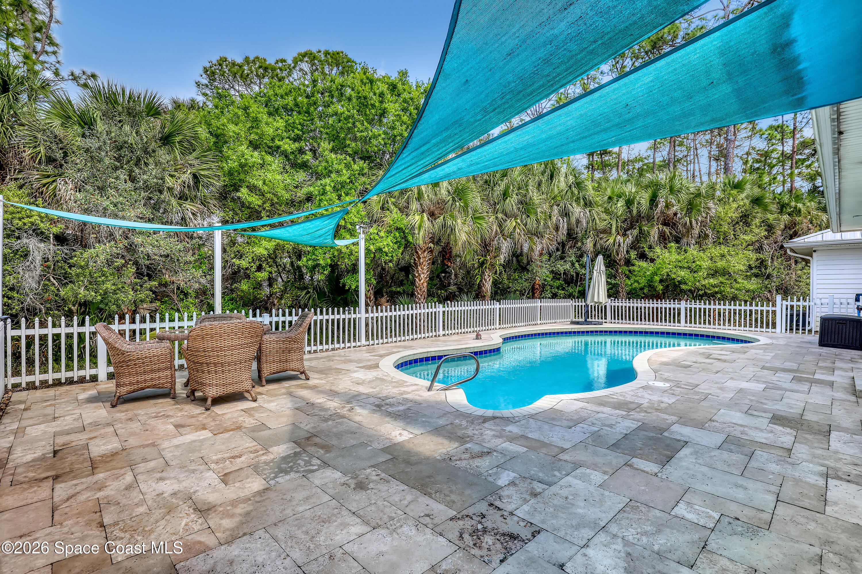 4200 Mustang Road Melbourne, FL 32934 - Photo 52 of 58 a view of a swimming pool with a patio