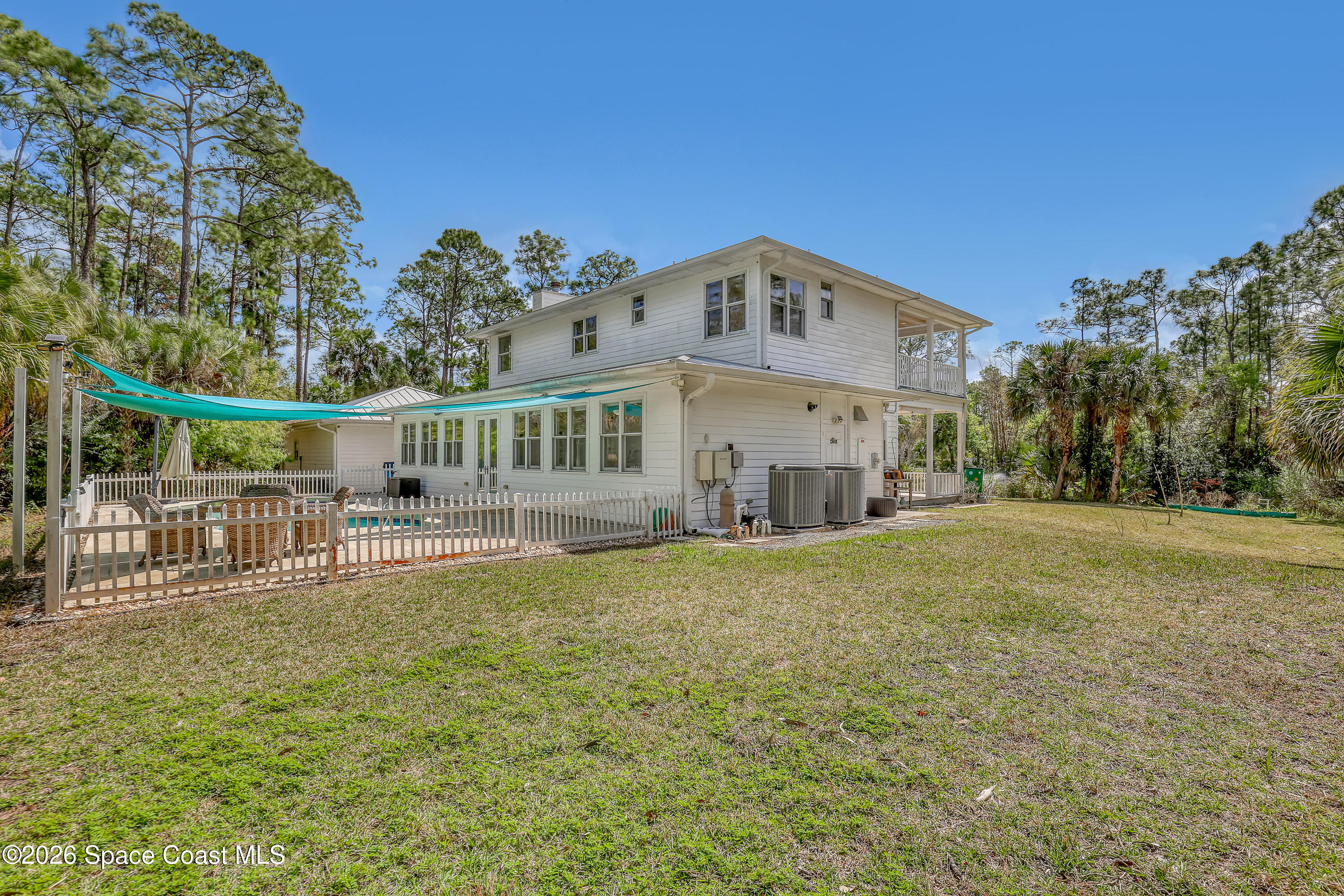4200 Mustang Road Melbourne, FL 32934 - Photo 54 of 58 a view of a house with a yard
