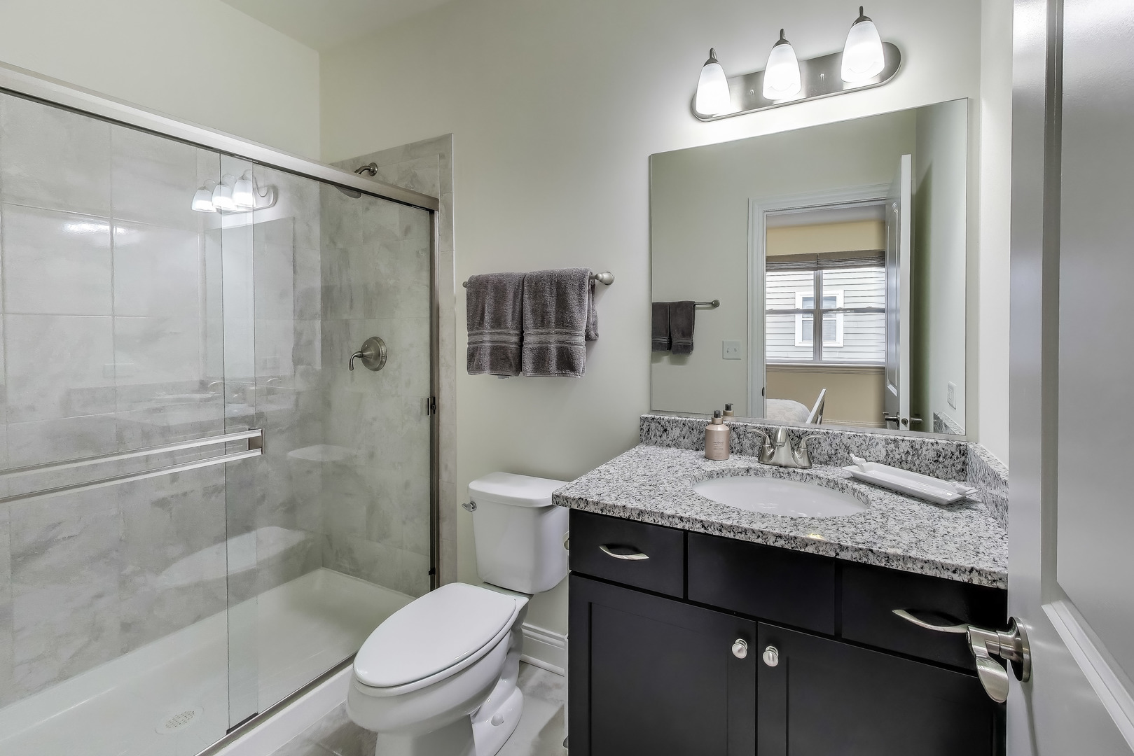 557 North Myrtle Avenue Elmhurst, IL 60126 - Photo 28 of 33 a bathroom with a granite countertop sink toilet a mirror and shower