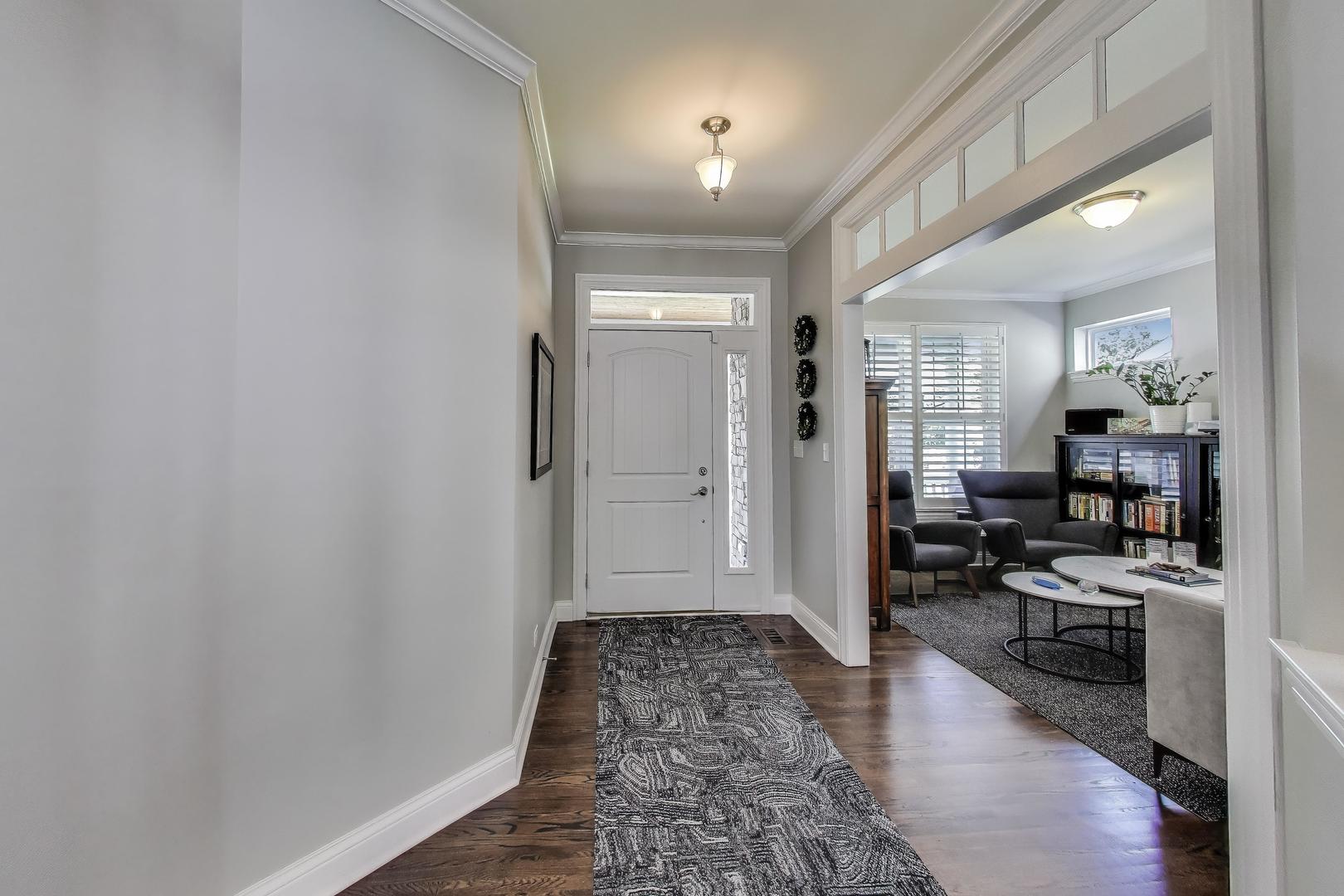 557 North Myrtle Avenue Elmhurst, IL 60126 - Photo 3 of 33 a view of a hallway and a livingroom with furniture