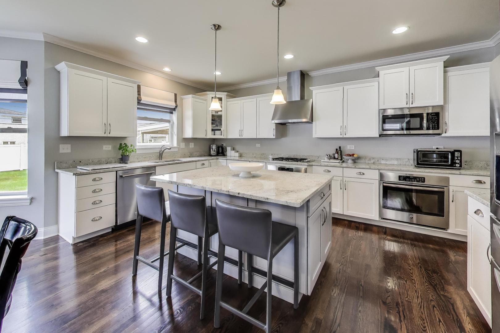 557 North Myrtle Avenue Elmhurst, IL 60126 - Photo 6 of 33 a kitchen with stainless steel appliances granite countertop a stove a sink a microwave a refrigerator and white cabinets with wooden floor