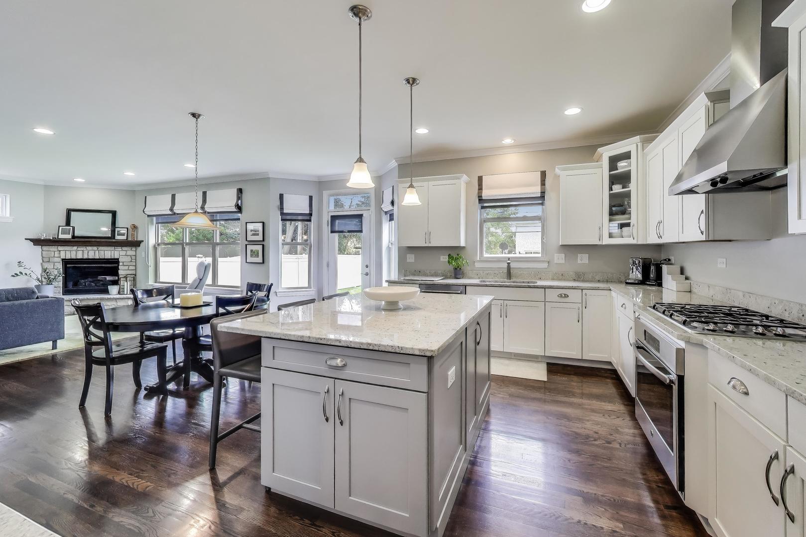 557 North Myrtle Avenue Elmhurst, IL 60126 - Photo 8 of 33 a kitchen with kitchen island granite countertop a sink a stove a counter space and a center island