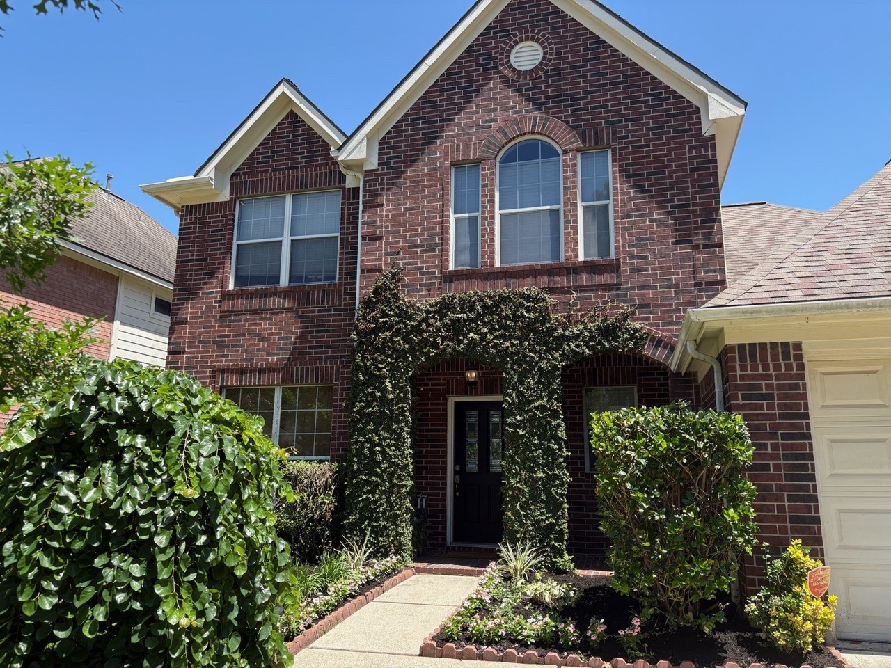 22402 Rue Canyon Court Katy, TX 77450 - Photo 3 of 18 A truly magical first impression! Rich, green ivy gracefully wraps around the arched entryway, creating a sophisticated and romantic focal point. A neat concrete walkway draws you past colorful flower borders straight to the handsome, dark-paneled front door.