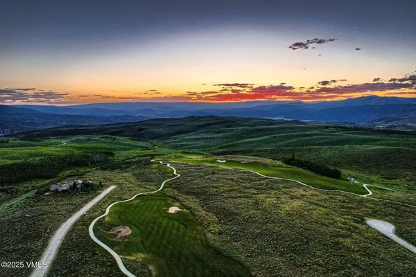 a view of a golf course with a swimming pool