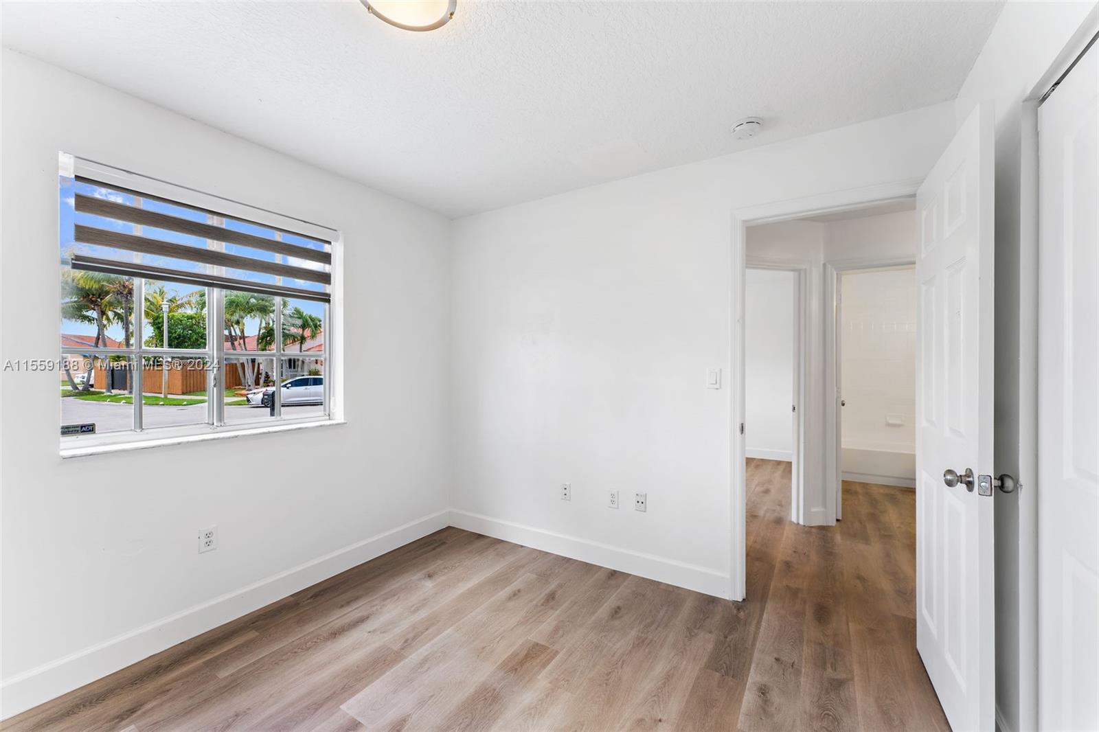 17767 Southwest 144th Avenue Miami, FL 33177 - Photo 15 of 21 an empty room with wooden floor and windows