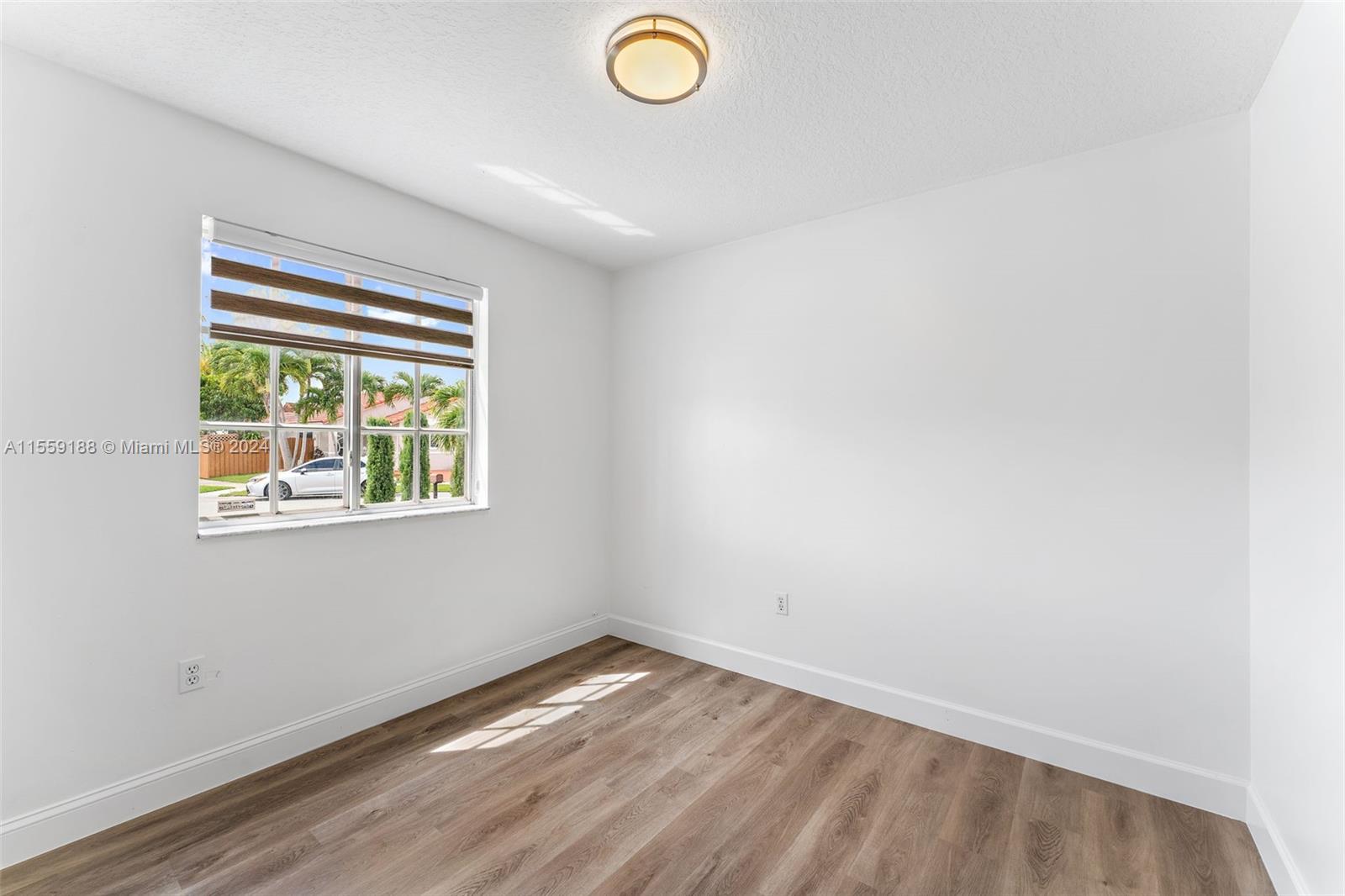 17767 Southwest 144th Avenue Miami, FL 33177 - Photo 16 of 21 an empty room with a window