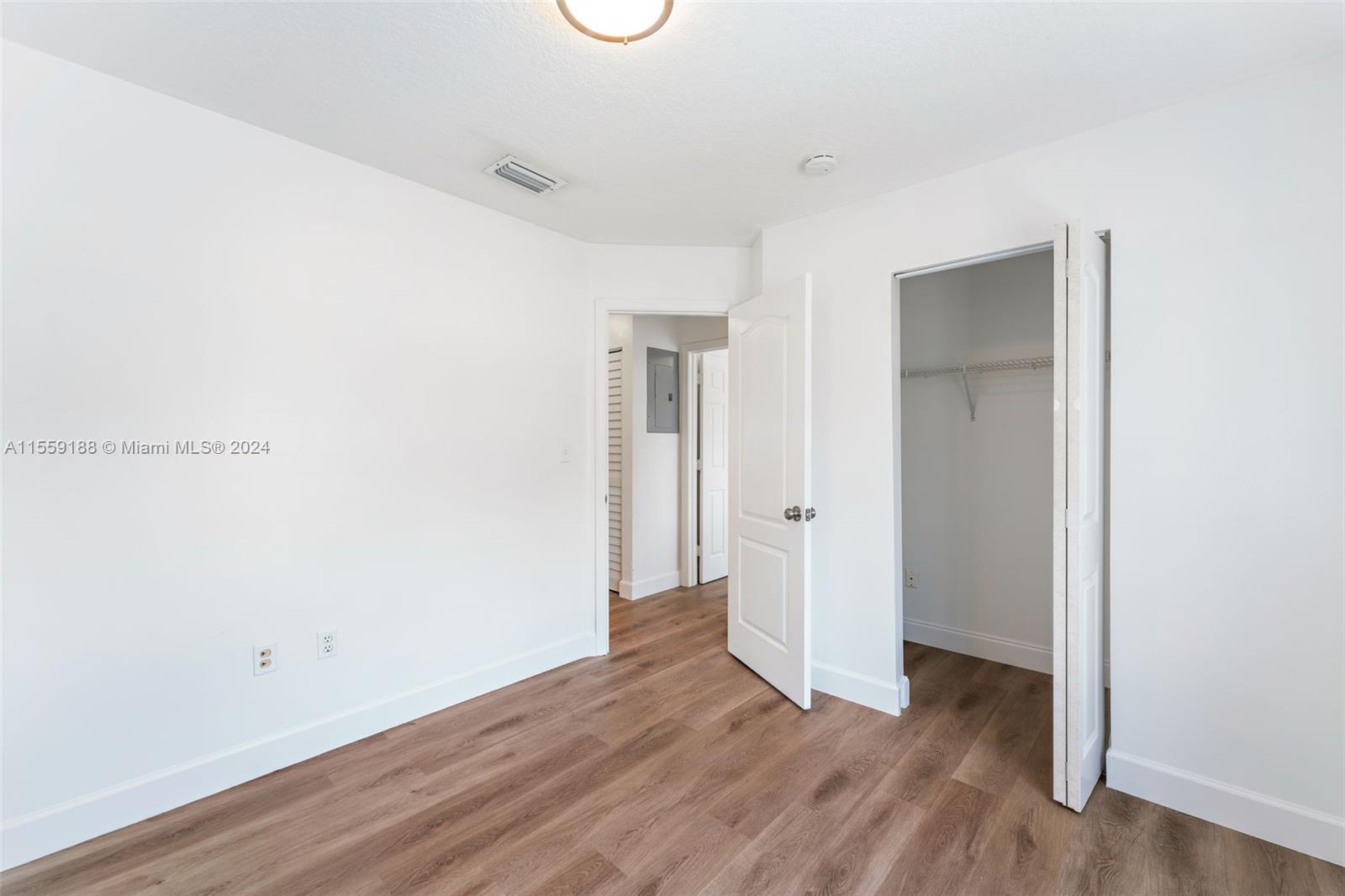 17767 Southwest 144th Avenue Miami, FL 33177 - Photo 17 of 21 a view of an empty room with wooden floor