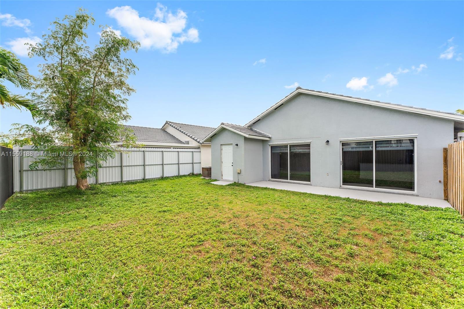 17767 Southwest 144th Avenue Miami, FL 33177 - Photo 20 of 21 a view of a house with a backyard