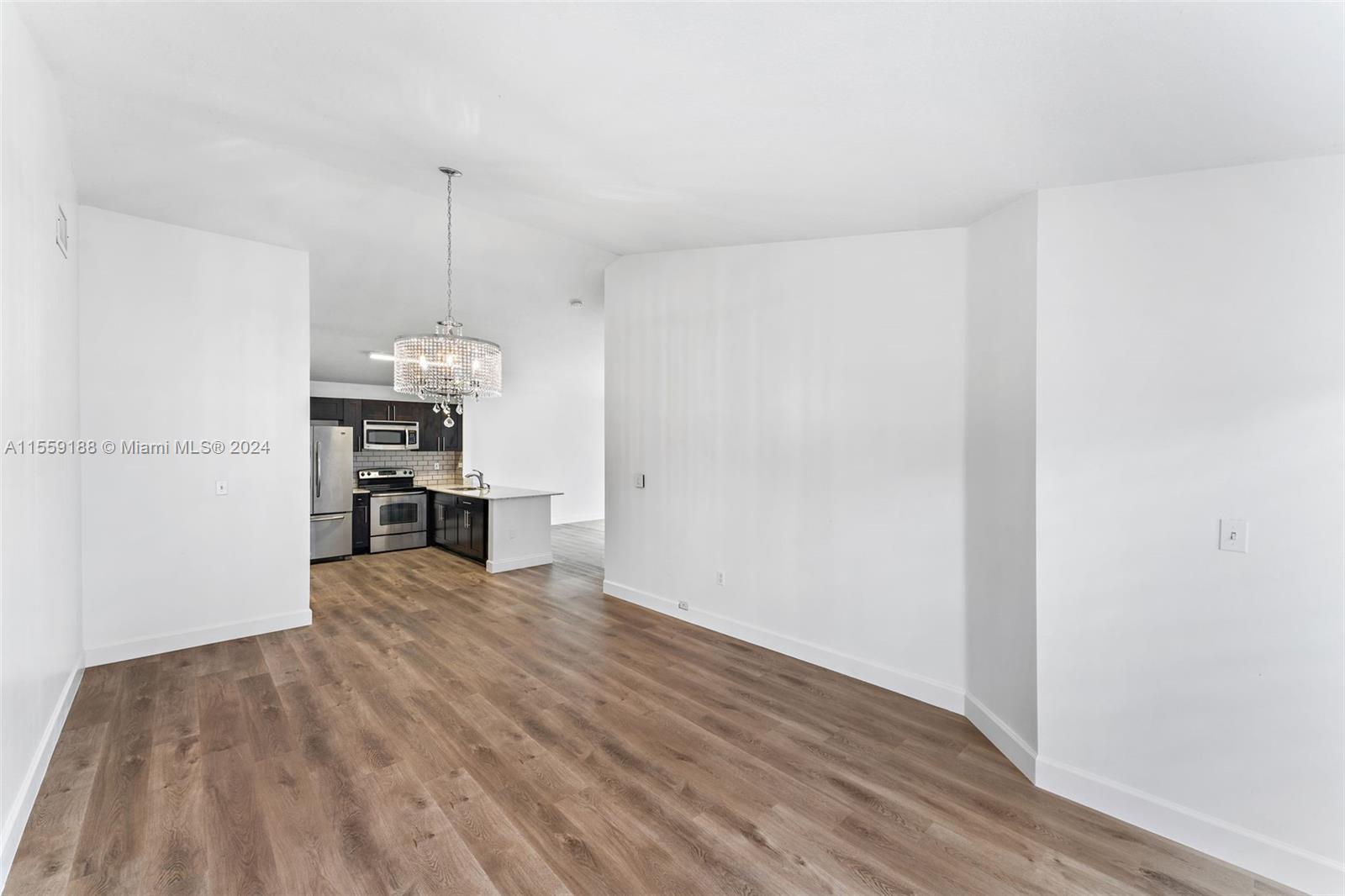 17767 Southwest 144th Avenue Miami, FL 33177 - Photo 2 of 21 a view of a kitchen with wooden floor electronic appliances and a window