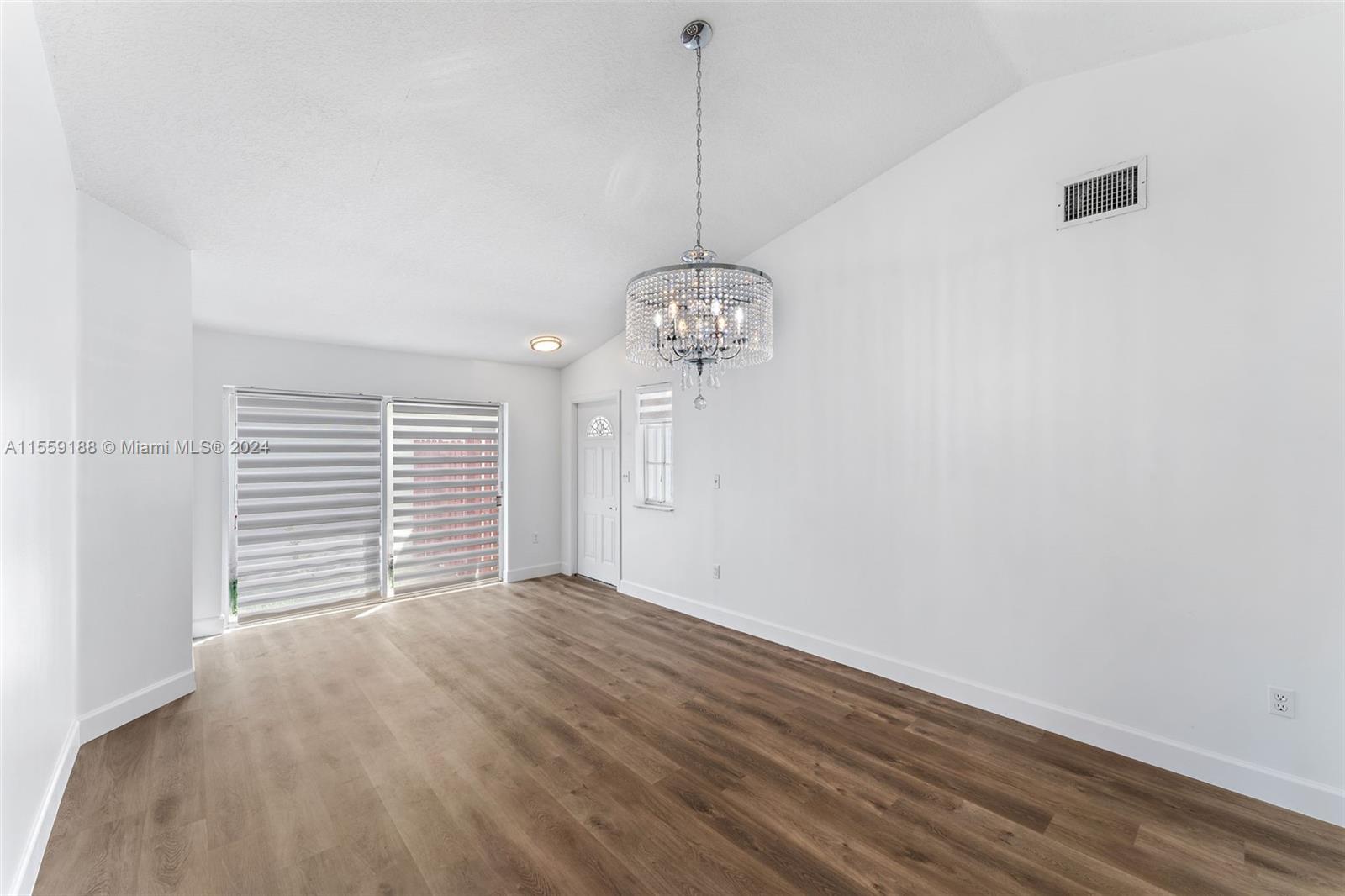 17767 Southwest 144th Avenue Miami, FL 33177 - Photo 3 of 21 a view of a room with a window and wooden floor