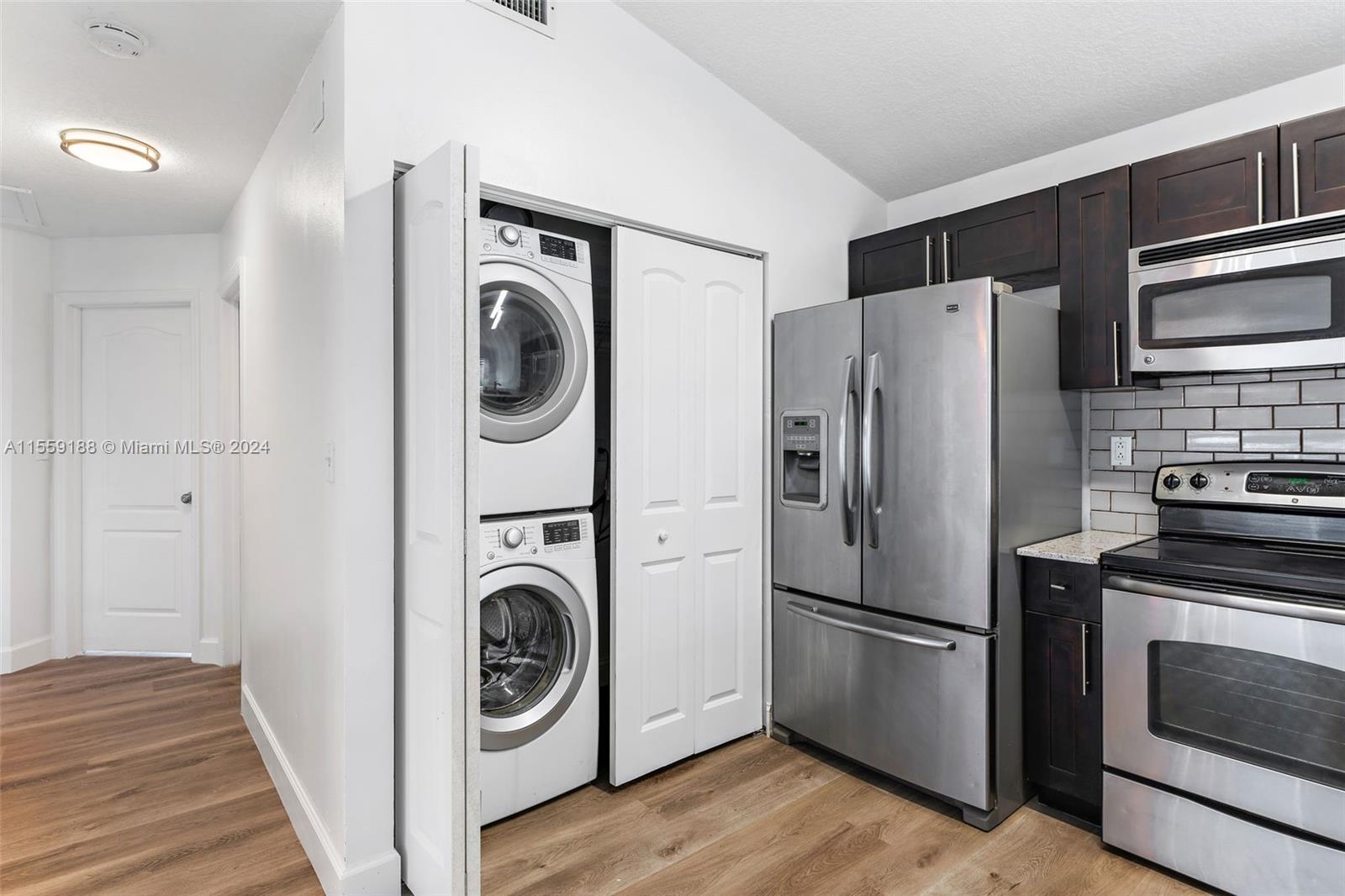 17767 Southwest 144th Avenue Miami, FL 33177 - Photo 5 of 21 a kitchen with stainless steel appliances granite countertop a refrigerator and a stove top oven