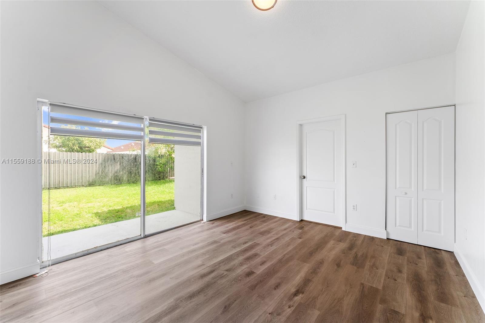 17767 Southwest 144th Avenue Miami, FL 33177 - Photo 9 of 21 a view of an empty room with glass door and a window
