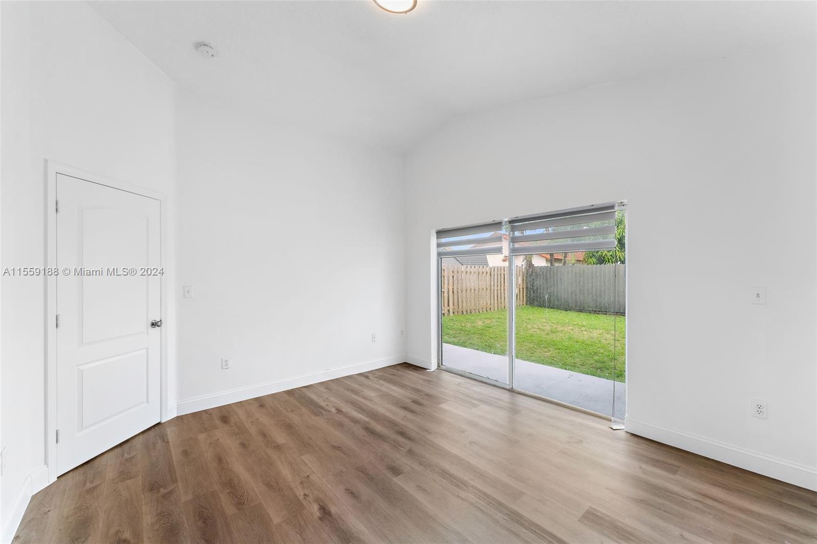 17767 Southwest 144th Avenue Miami, FL 33177 - Photo 10 of 21 a view of an empty room with wooden floor and a window