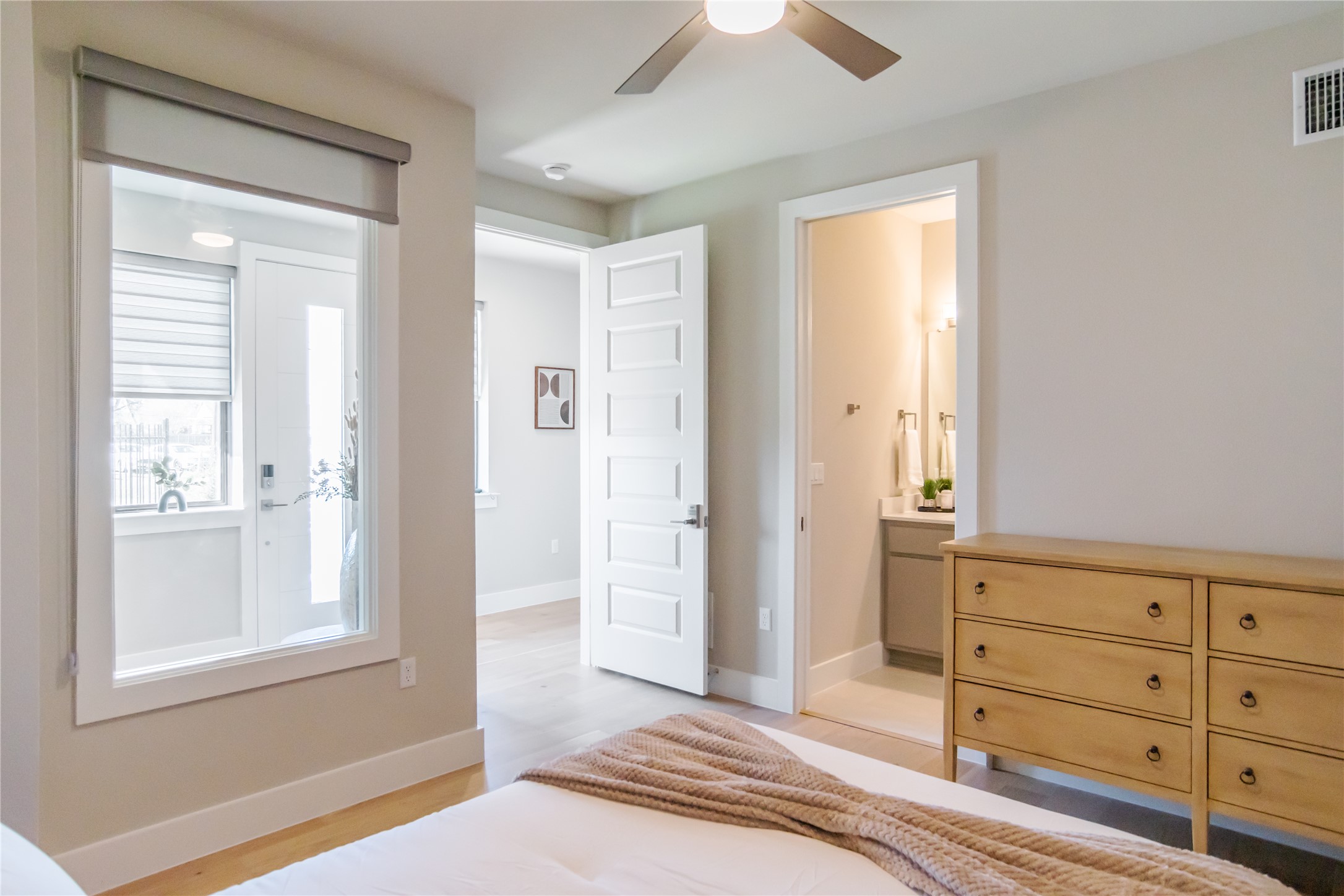 13309 Morris Road, Unit 11 Austin, TX 78729 - Photo 28 of 31 A tranquil bedroom provides comfort with an adjacent bath and natural wood flooring.