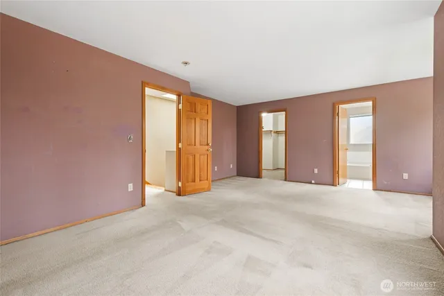 an empty room with windows and closet