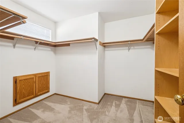 a view of walk in closet with empty racks