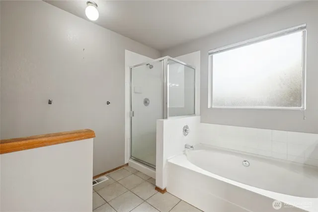 a bathroom with a bathtub and a shower