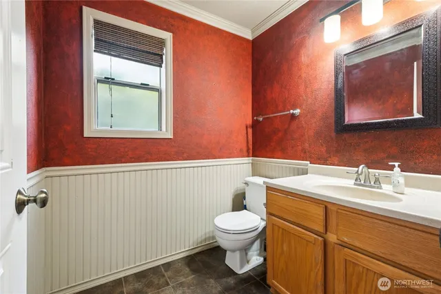 a bathroom with a toilet sink and mirror
