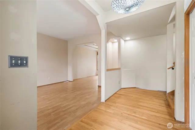 a view of a big room with wooden floor and a bathroom