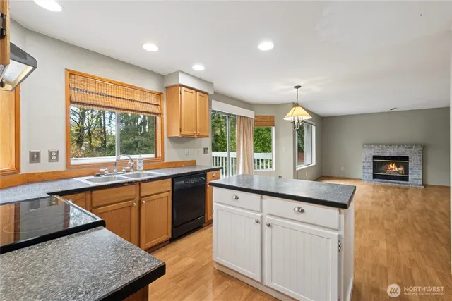 a large kitchen with a large window and stainless steel appliances