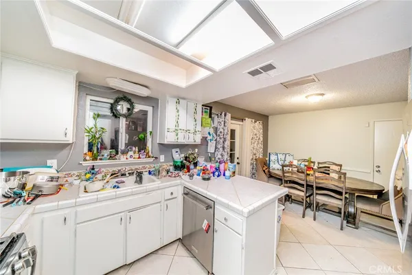 a kitchen with a sink and chairs