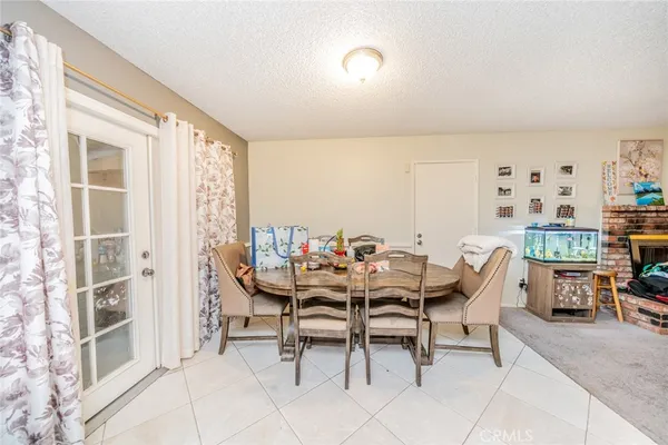 a dining room with furniture and a floor to ceiling window