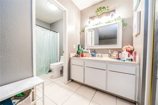 a bathroom with a sink mirror and toilet