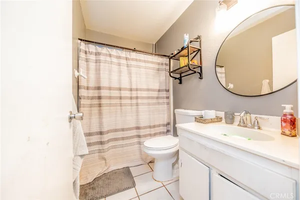 a bathroom with a toilet a sink and a mirror
