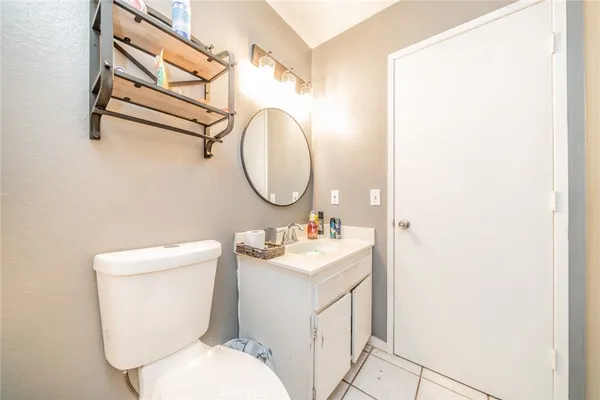 a bathroom with a sink mirror vanity and toilet