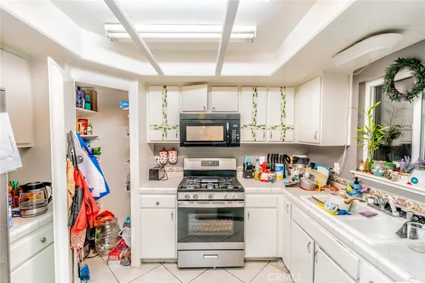 a kitchen that has a lot of cabinets dryer and a window