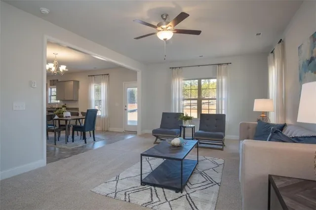 a living room with furniture a table and a chandelier