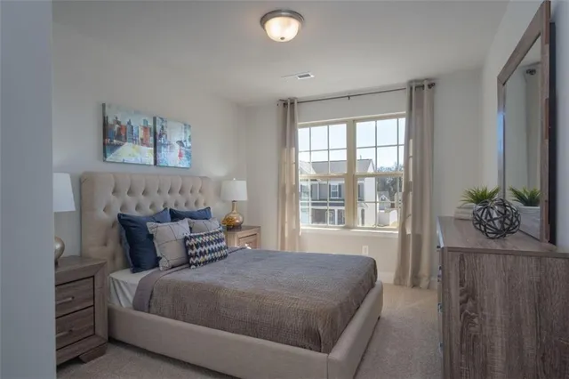 a bedroom with a bed a couch and a window