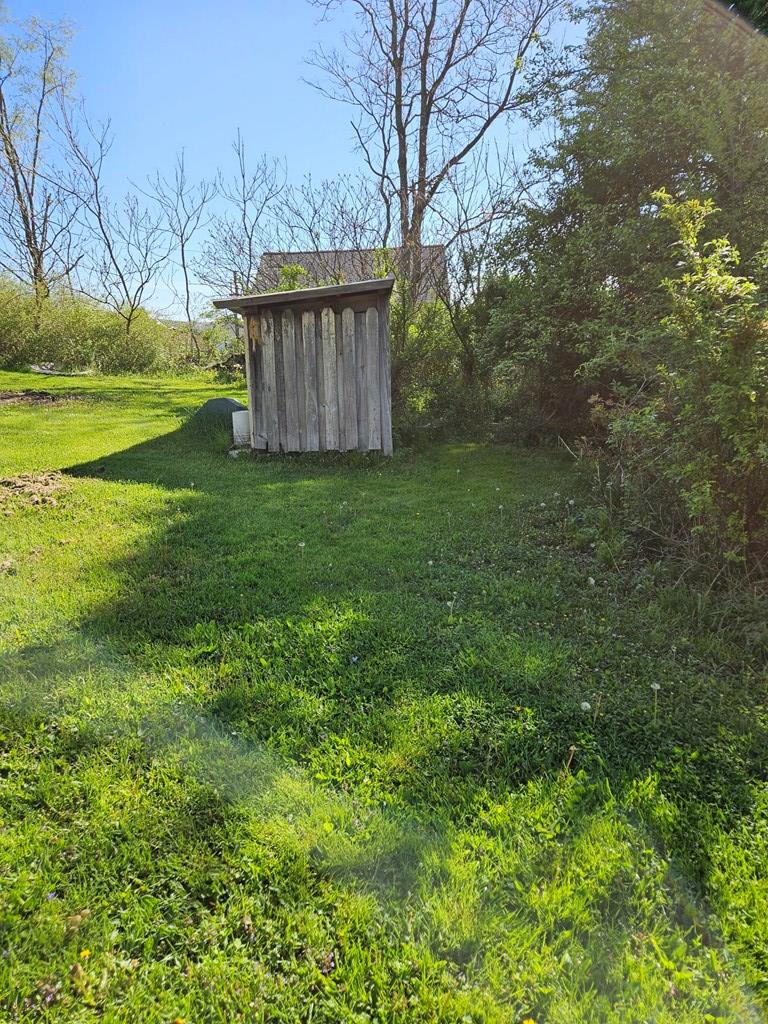 1067 Perryville Road Parker, PA 16049 - Photo 4 of 8 a view of a backyard with large trees