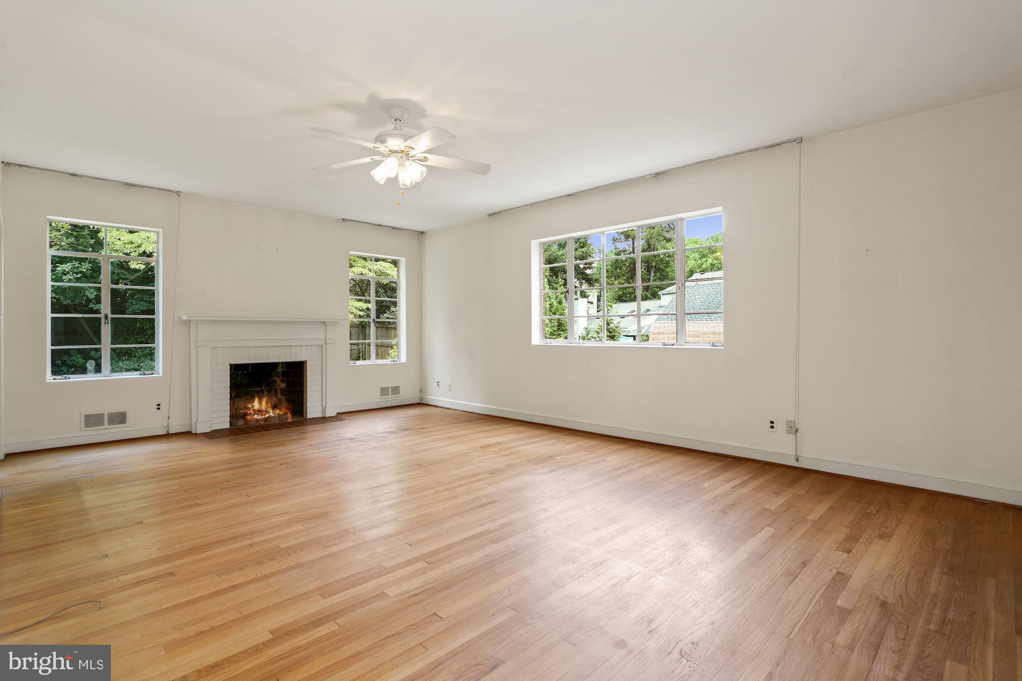 7900 Glendale Road Chevy Chase, MD 20815 - Photo 11 of 32 Main level primary bedroom with fireplace