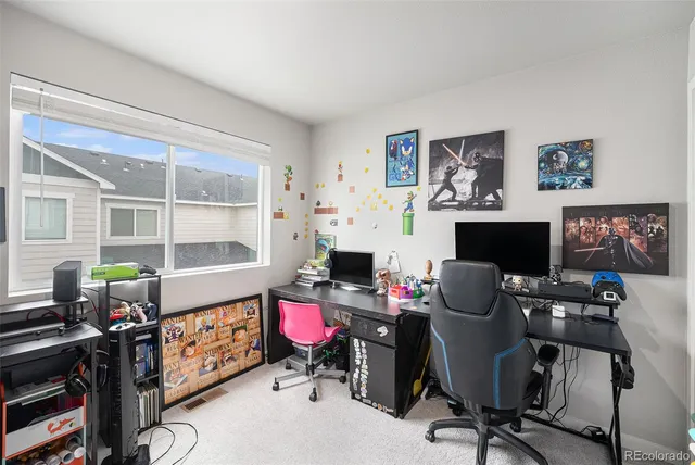 a view of a workspace with furniture and a window