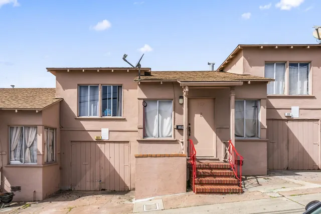 a front view of a house with wooden stairs