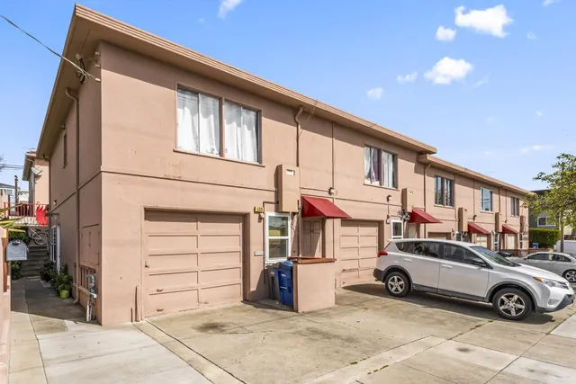 a view of a car park in front of house