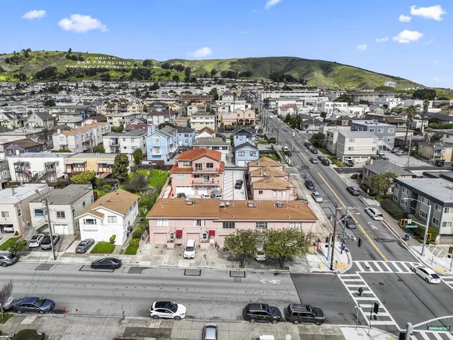 an aerial view of residential houses with outdoor space