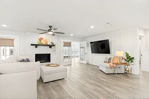 a living room with furniture fireplace and flat screen tv