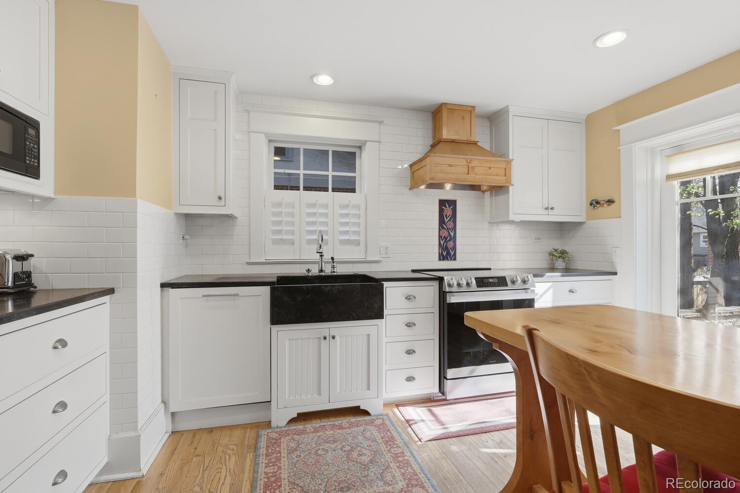 1630 Albion Street Denver, CO 80220 - Photo 13 of 28 a kitchen with stainless steel appliances a stove a sink island and a refrigerator