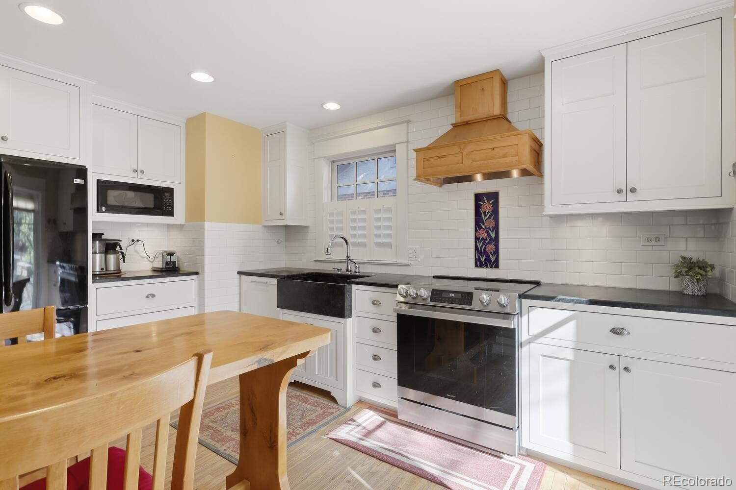 1630 Albion Street Denver, CO 80220 - Photo 15 of 28 a kitchen with stainless steel appliances granite countertop a stove a sink and a refrigerator