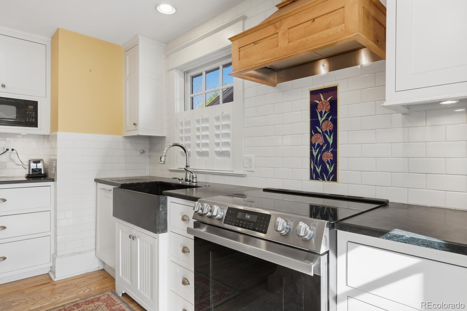 1630 Albion Street Denver, CO 80220 - Photo 16 of 28 a kitchen with a stove and a sink