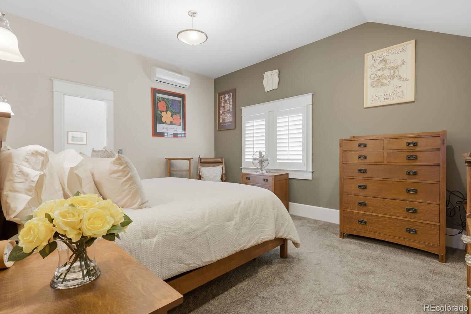 1630 Albion Street Denver, CO 80220 - Photo 19 of 28 a bedroom with a bed and a dresser
