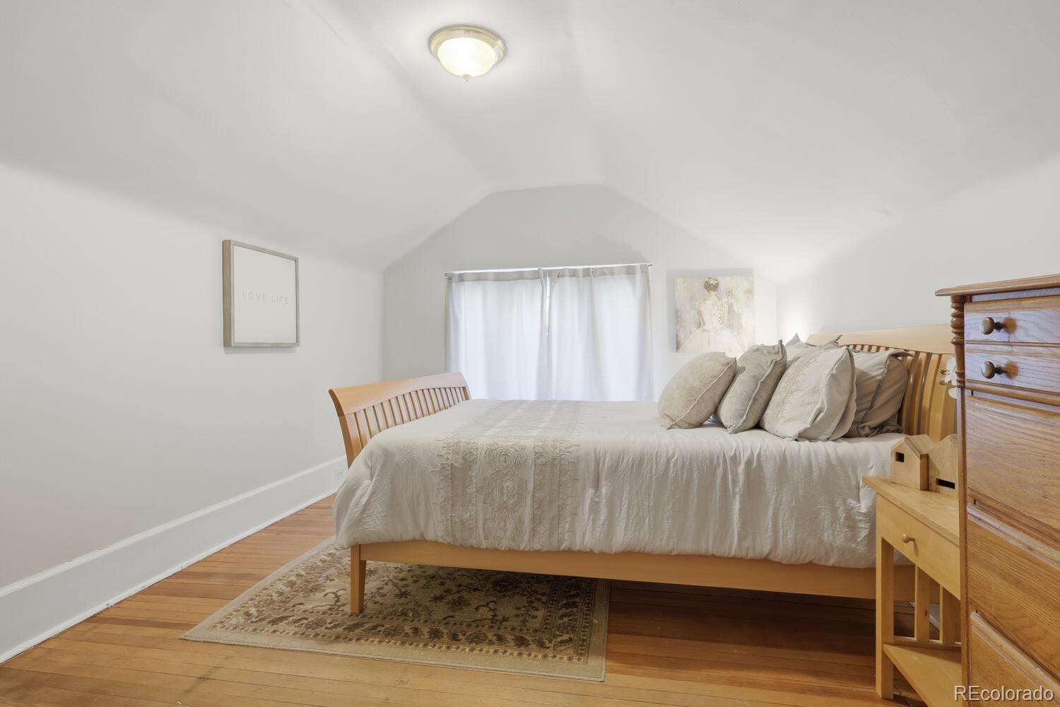 1630 Albion Street Denver, CO 80220 - Photo 23 of 28 a bedroom with a bed and wooden floor