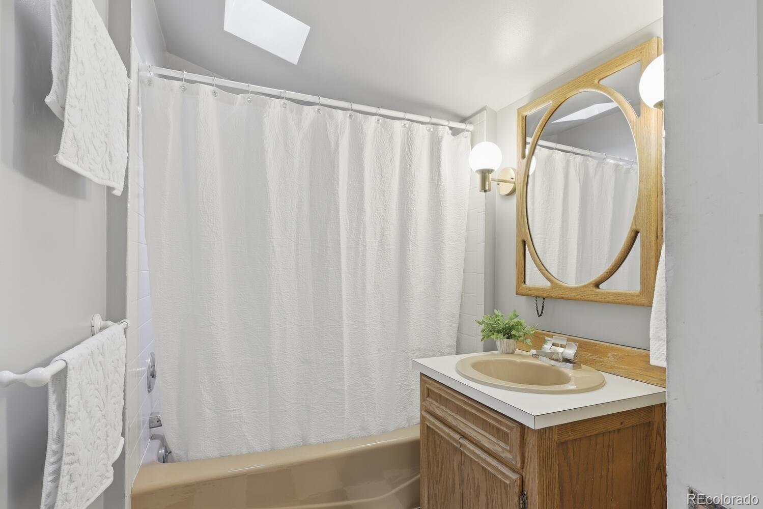 1630 Albion Street Denver, CO 80220 - Photo 24 of 28 a bathroom with a sink and a mirror