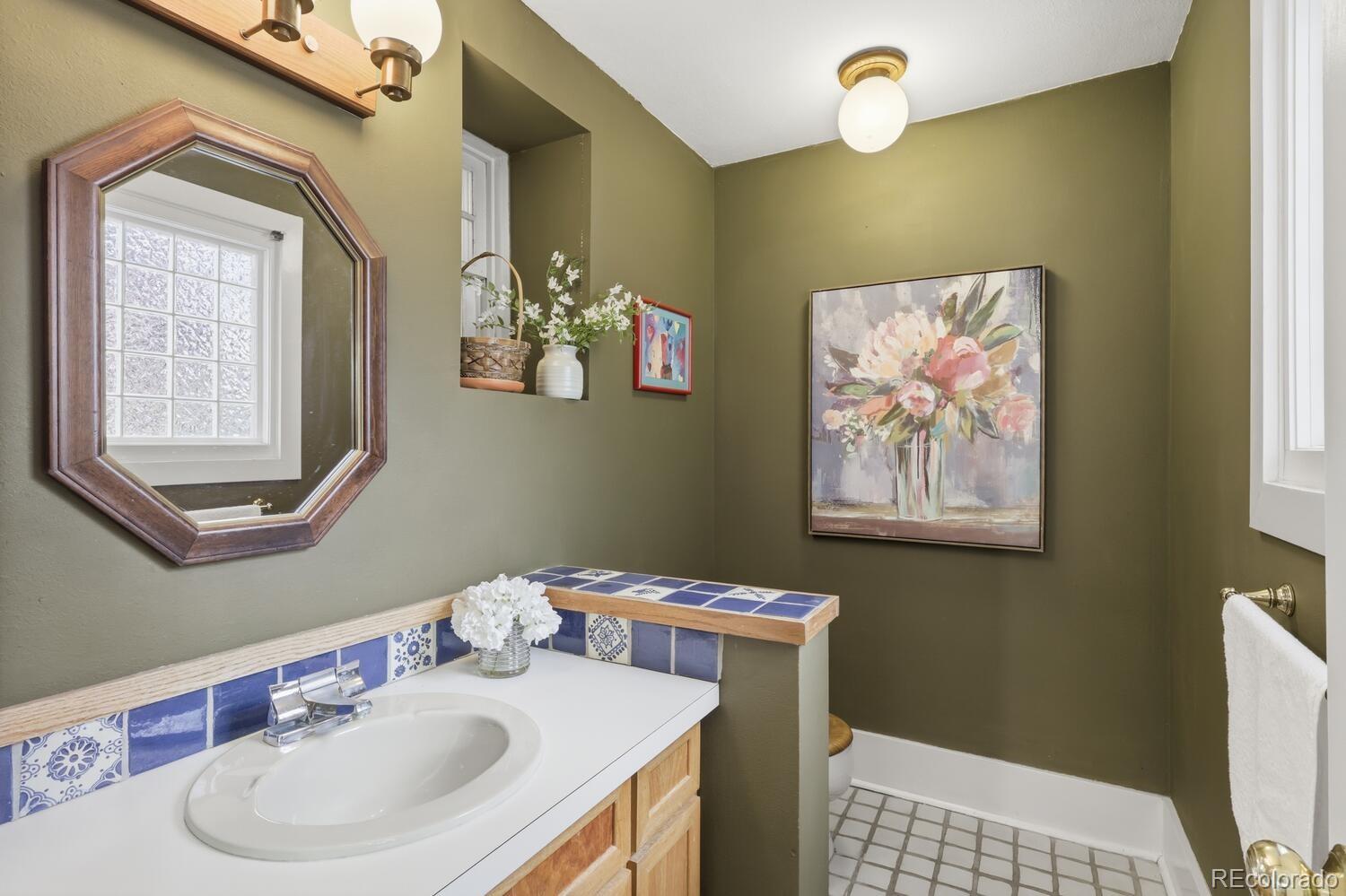 1630 Albion Street Denver, CO 80220 - Photo 10 of 28 a bathroom with a sink vanity and a mirror