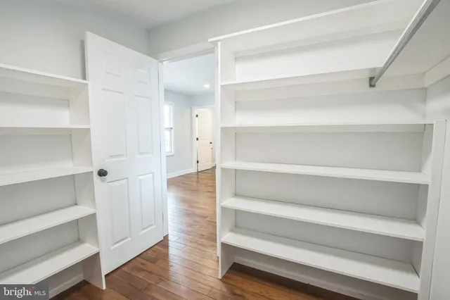 a view of walk in closet with empty racks