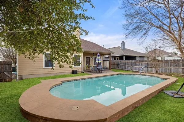 a view of a house with swimming pool and porch